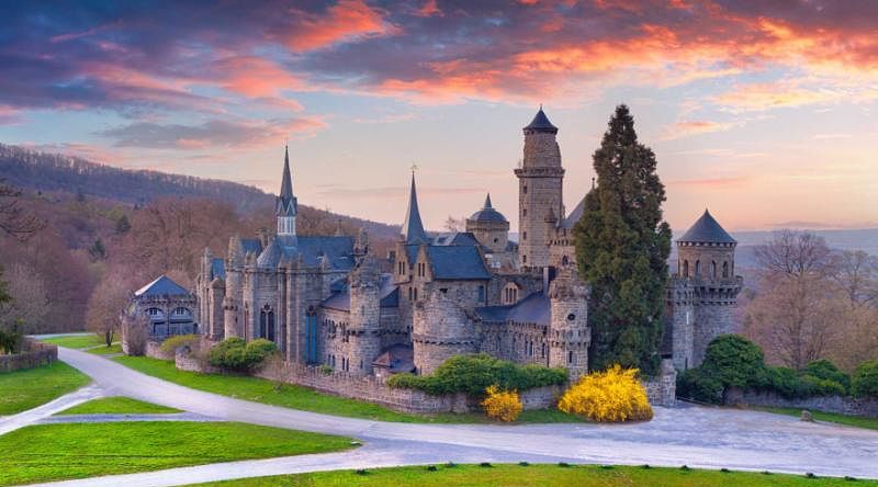 A Luxury Fairy Tale Tour of Germany Colorful spring sunset in the Wilhelmshohe Castle, Hessen, Kassel