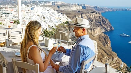 A couple having dinner outside in Santorini, Greece.
