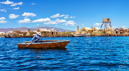 Rowboat and floating island on Lake Titicaca in Peru