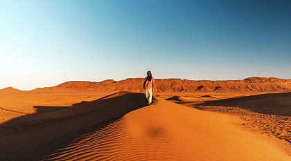 Solo traveler on sand dunes in Morocco