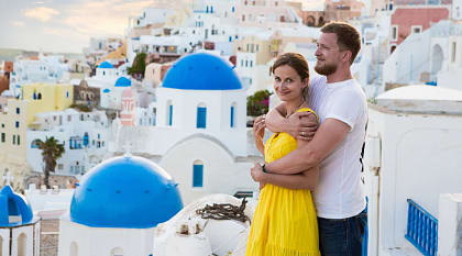 Couple enjoying the view of Santorini Island in Greece