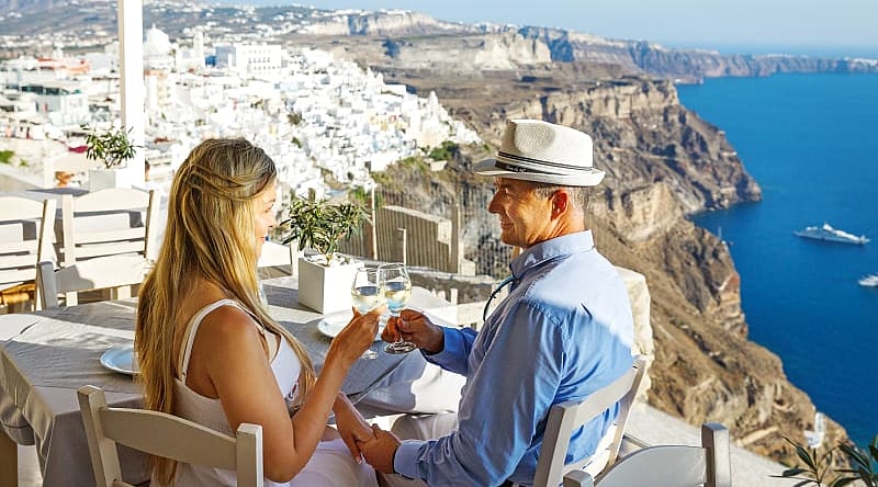 A couple having dinner outside in Santorini, Greece. A couple having dinner outside in Santorini, Greece.