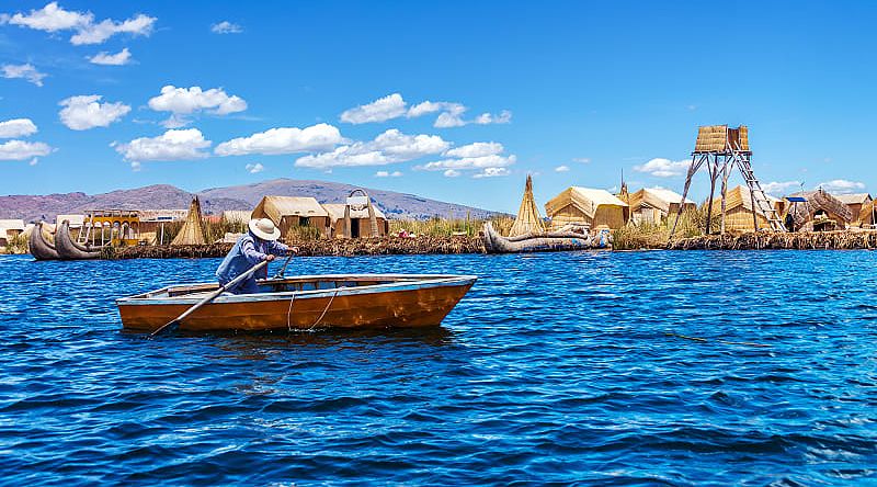 Rowboat and floating island on Lake Titicaca in Peru