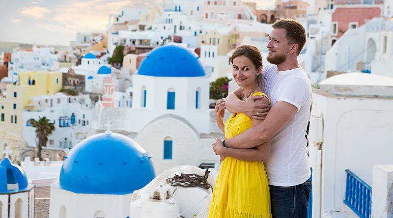 Couple enjoying the view of Santorini Island in Greece