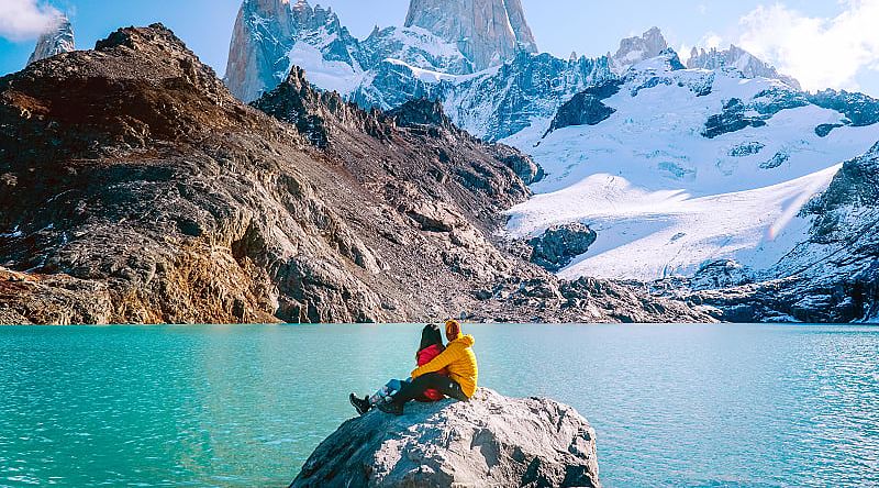 Couple admiring mount Fitzroy in the Argentinian Patagonia Couple admiring mount Fitzroy in the Argentinian Patagonia