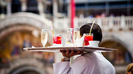 Waiter serving aperitif drinks in Venice, Italy