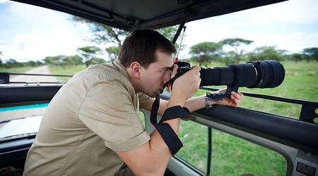 Photographer taking pictures on game drive in Tarangire National Park, Tanzania