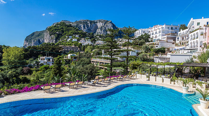 Resort pool on Carpri island with beautiful views of rocky cliffs, Italy