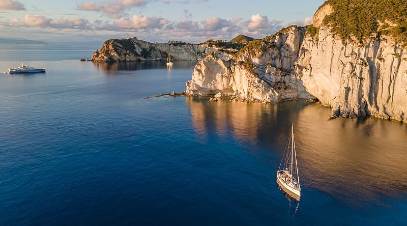 Sailboats at sunset around the beautiful island of Ponza in Italy