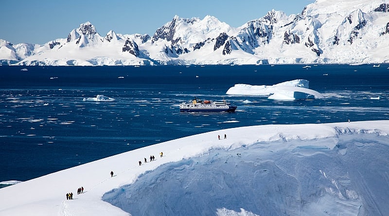 Tourists hiking on glacier during an excursion in Antarctica