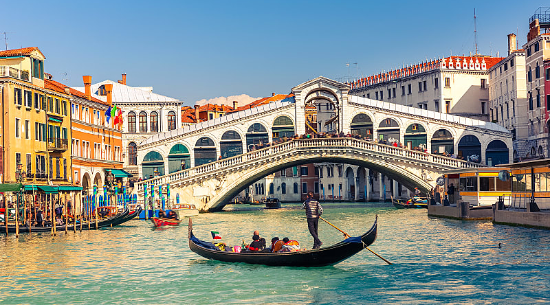 Gondola ride near the Rialto Bridge on the Grand Canal in Venice, Italy