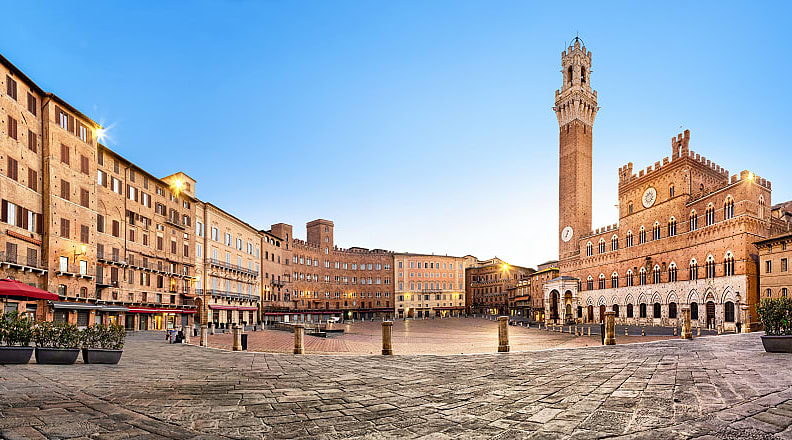 Piazza del Campo with gothic town hall building and tower in Siena, Italy