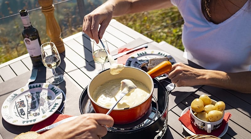 Two women enjoy a fondue on the Moleson in Gruyères, Switzerland