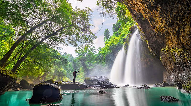 Hiker at Haew Suwat waterfall in Khao Yai National Park, Thailand