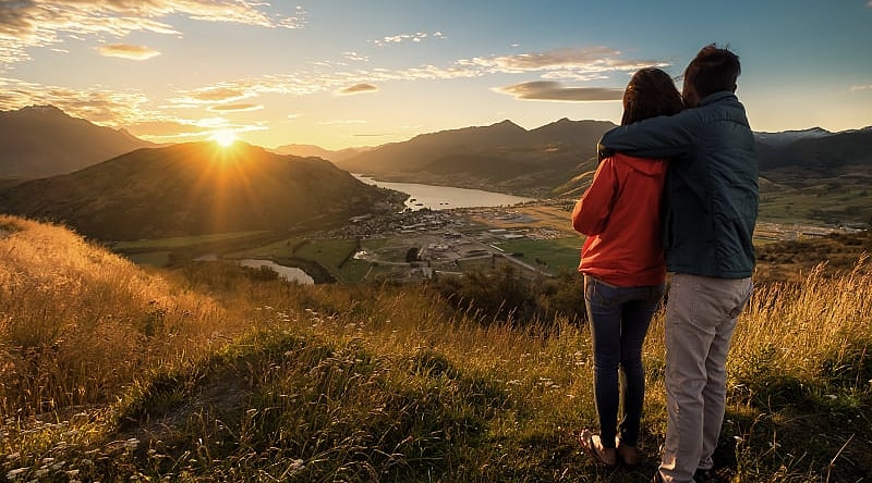 Couple enjoying a sunset in New Zealand