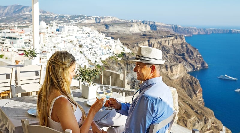 A couple having dinner outside in Santorini, Greece.