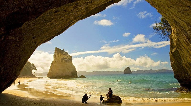 Family at Cathedral Cove in the Coromandel Peninsula, New Zealand
