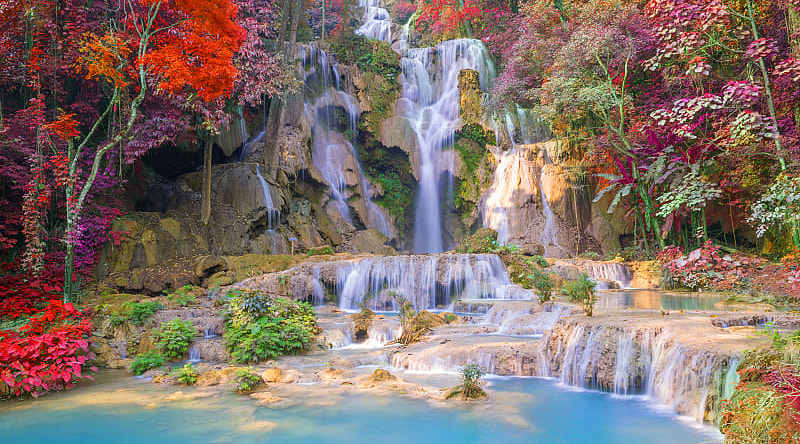 Beautiful autumn colors surround Kuang Si Waterfall in Luang Prabang, Laos.