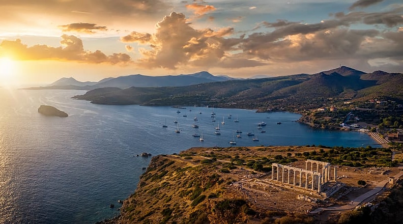 Aerial view of sunset over Cape Sounion with temple ruins in Greece