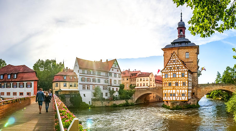 Couple walking across a bridge in Bamberg, Germany.