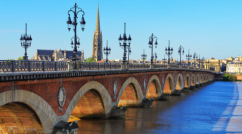 Bordeaux river bridge with St. Michel Cathedral in France