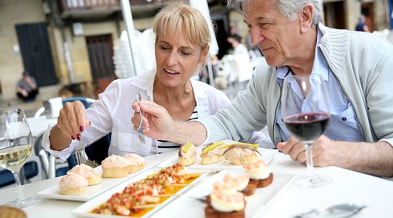 Couple enjoys some food and wine in Spain