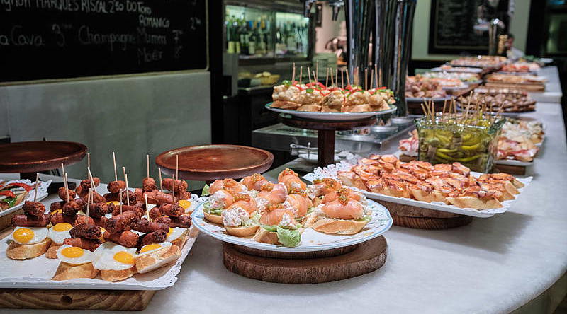 Spanish tapas, or pintxos, on the counter at a bar in San Sebastian, Spain