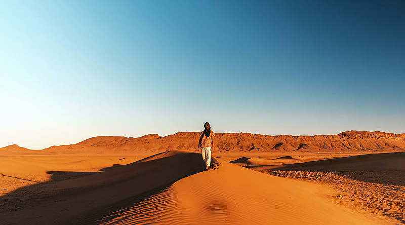 Solo traveler on sand dunes in Morocco