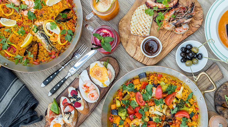 Savor the flavors of homemade food and big city cuisine on this trip to Spain