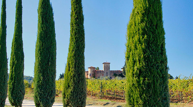 Gabbiano Castle with vineyards and cypress trees in Tuscany, Italy