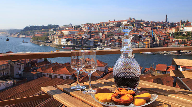 Table set with wine and pastries overlooking Porto, Portugal