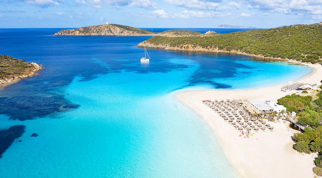 Clear blue waterof the Mediterrenean and golden sand at Tuerredda Beach in Tuerredda Beach in Sardinia, Italy