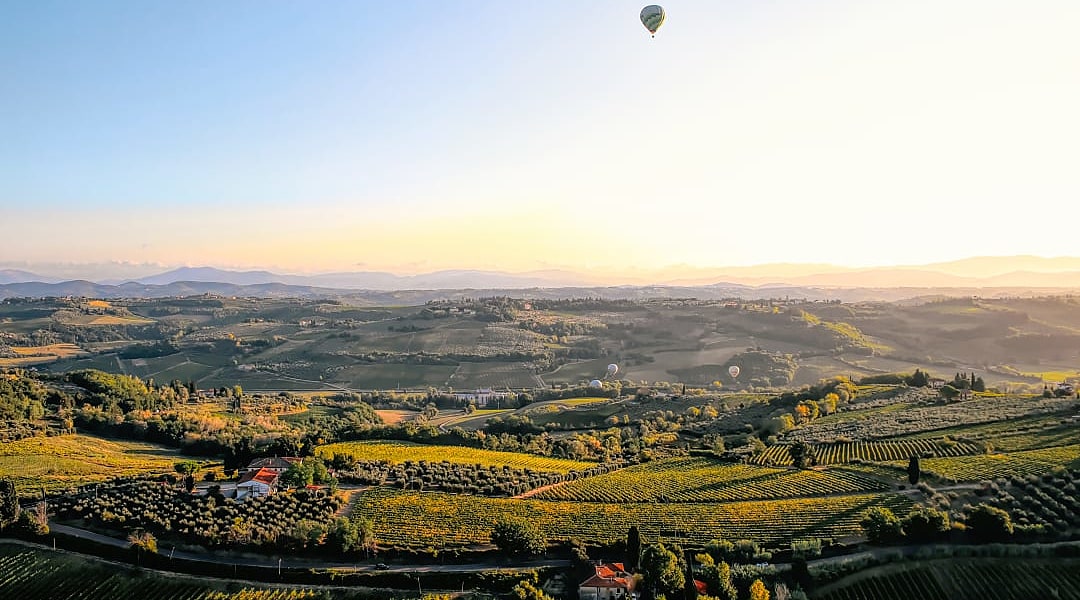 Sunrise hot air balloon ride over the vineyards of Tuscany, Italy