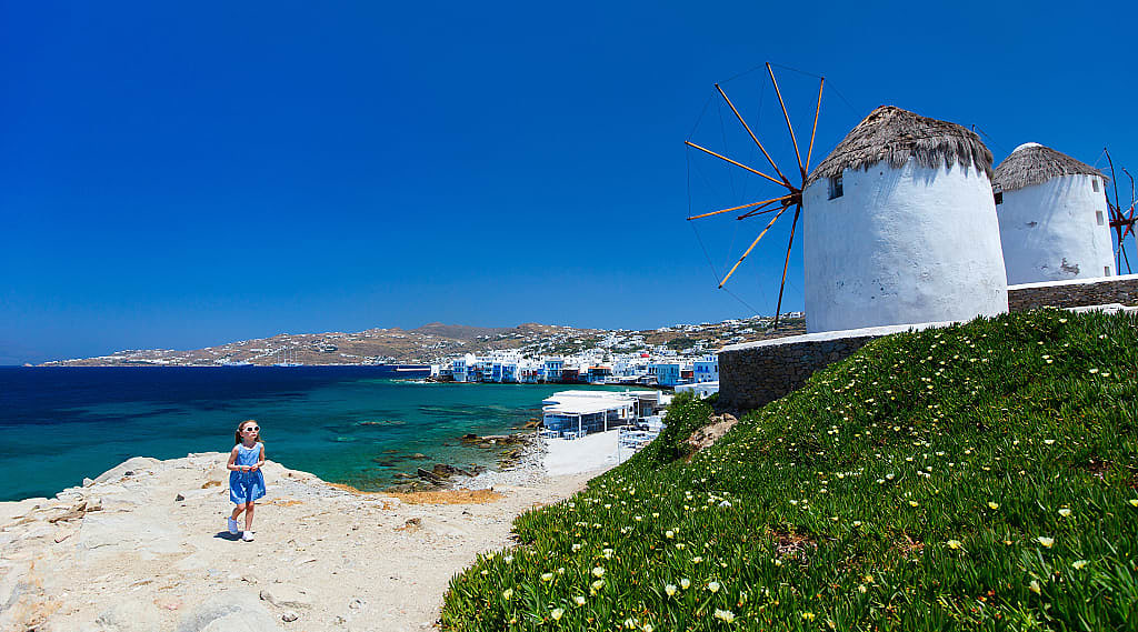 Girl and windmills in Mykonos