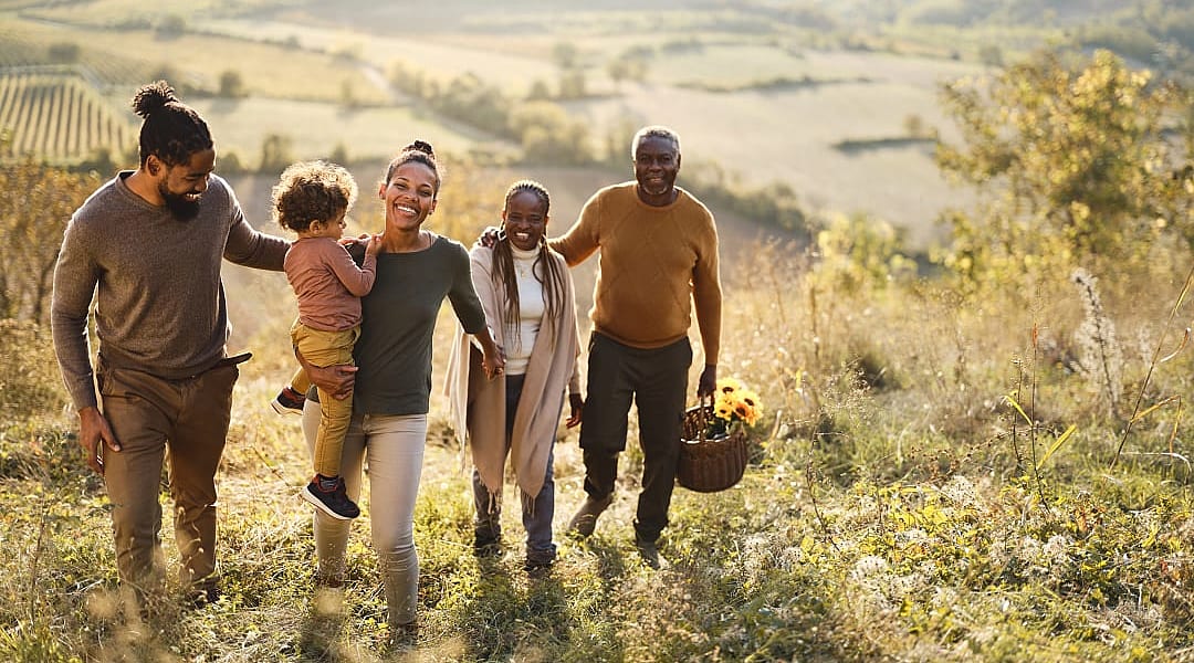 Multi-generational family exploring vineyards during the fall