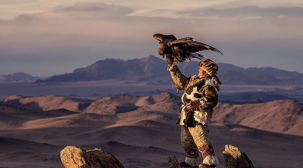 Mongolian eagle hunter in traditional fox dress