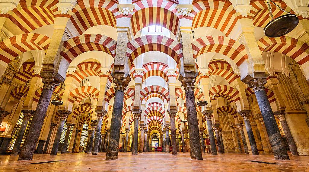 Moorish architecture of the red and white arches within the Mosque-Cathedral of Córdoba, Spain