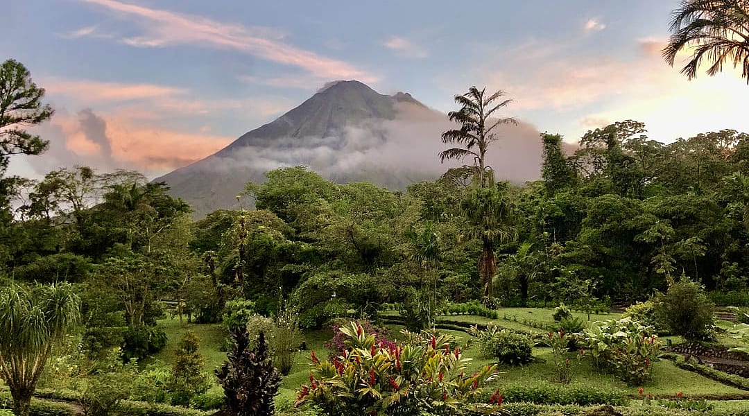 Arenal Volcano in Costa Rica, surrounded by lush rainforest.