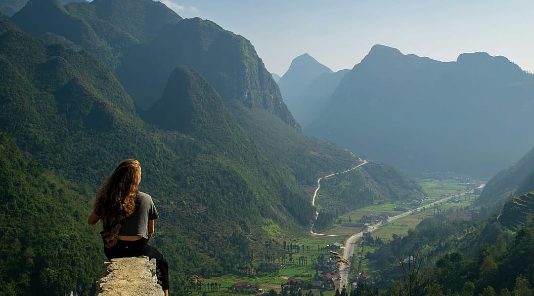 Woman sitting at an overlook along the