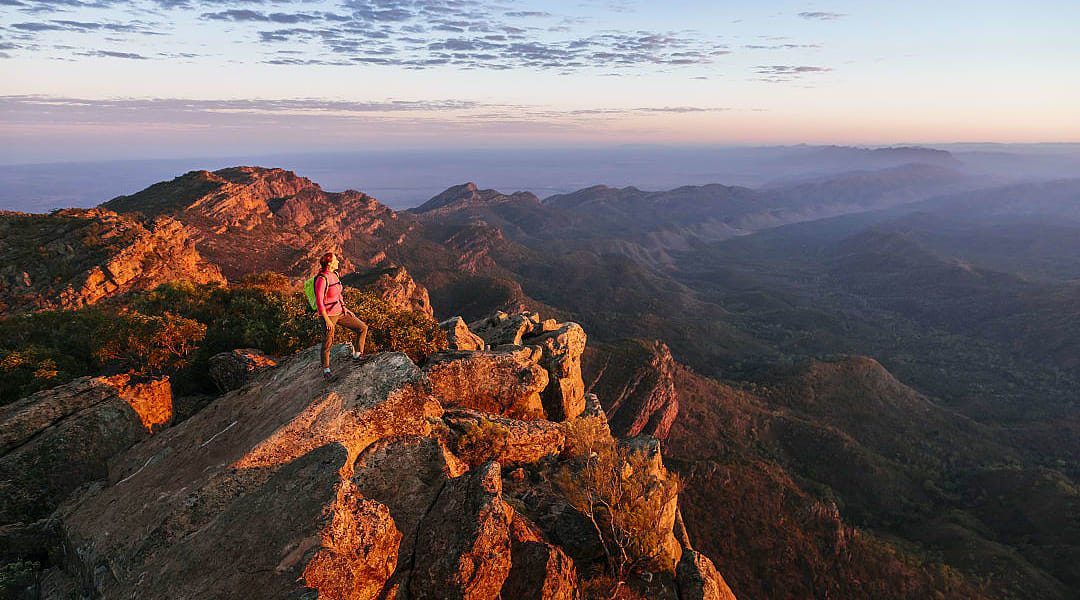 Woman hiking St Mary Peak in Flinders Ranges National Park, Australia