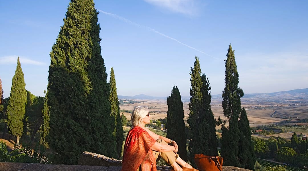Senior woman enjoying the view of the Tuscan hills from Pienza, iTaly
