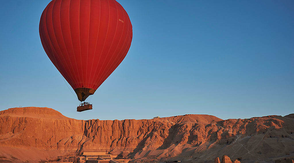 Hot air balloon over Asasif Valley and the Temple of Hatshepsut in Luxor, Egypt