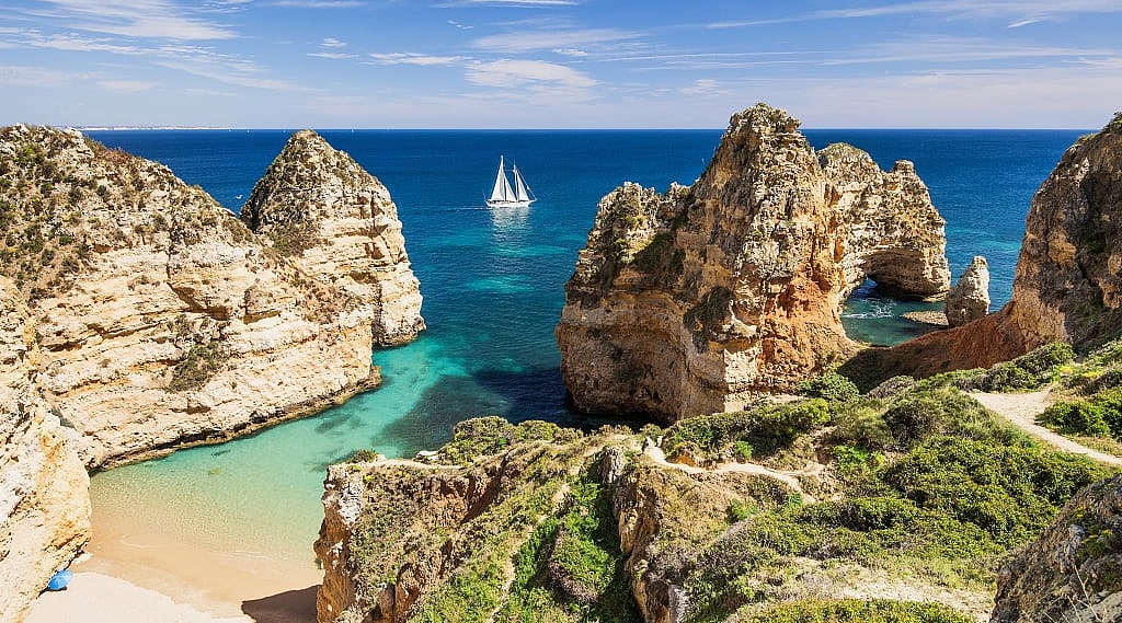 Sailing the beautiful blue bay near Lagos, in the Algarve region in Portugal