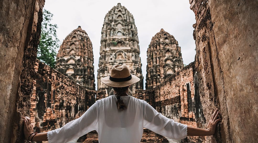 raveler explores the ancient Khmer-style temple ruins of Wat Si Sawai in Sukhothai, Thailand.