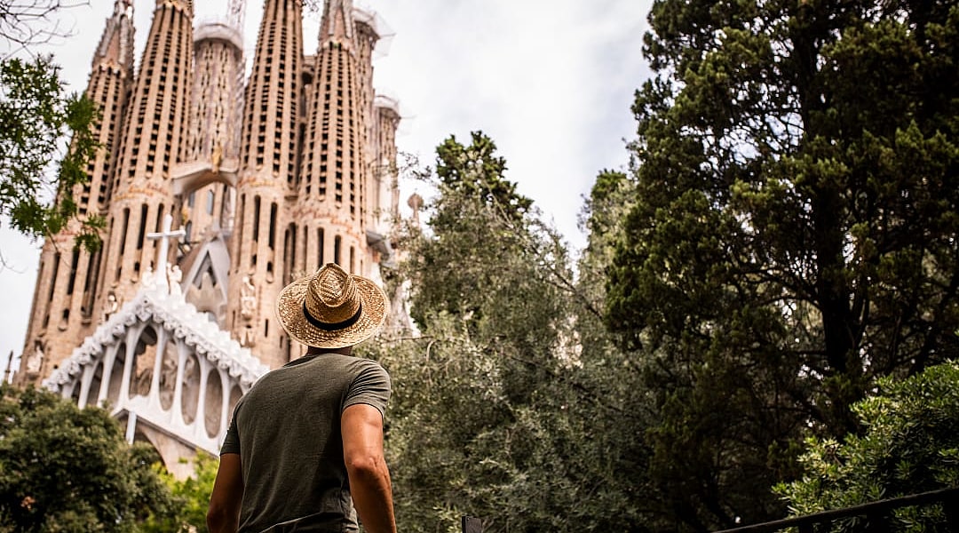 Man looking up at La Sagrada Familia in Barcelona, Spain