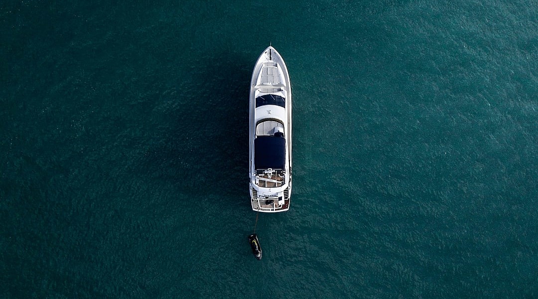 Aerial view of a luxury yacht anchored in turquoise water