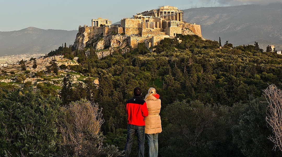 A couple admires the Acropolis in Athens