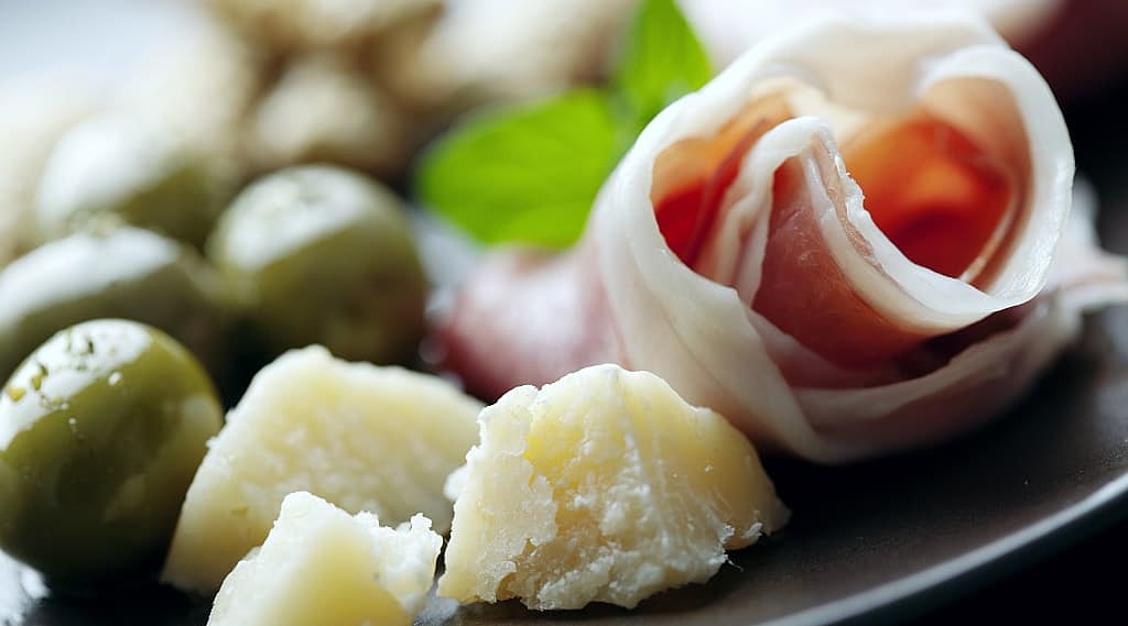 The famous Parma prosciutto and parmesan with green olives