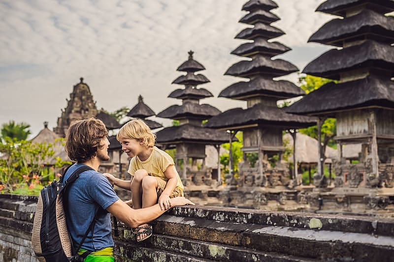 Dad and son tourists in traditional Balinese hindu temple
