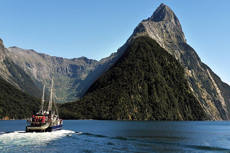 Ship under Mitra Peak in Fiordland National Park on South Island, New Zealand